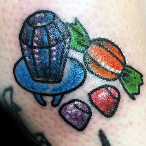 Colorful candy tattoo featuring a Ring Pop, wrapped candy, and gumdrops with bold outlines and a playful, nostalgic design.
