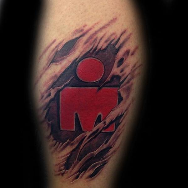 Tattoo of the Ironman logo, with the design appearing to break through the skin, symbolizing strength, endurance, and determination.