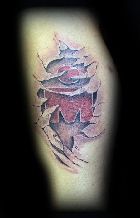 Tattoo design featuring a torn skin effect revealing the bold "M" logo, symbolizing strength and endurance, likely representing the Ironman race.