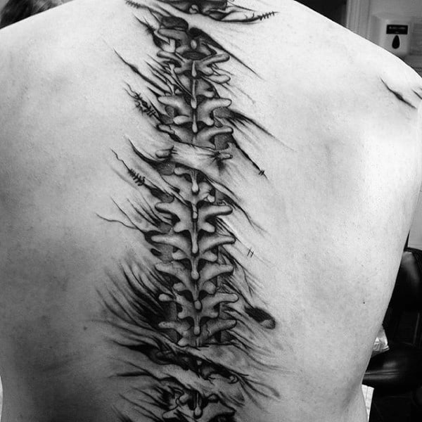 Black and grey tattoo of a spine on a person's back