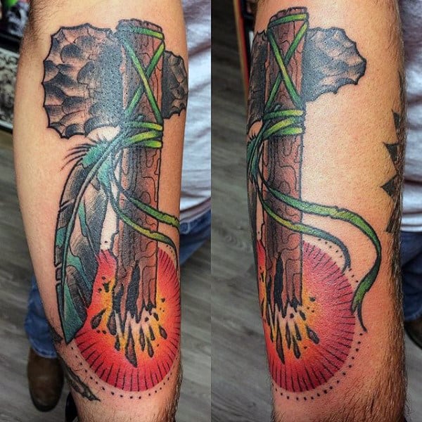 Rising Sun Broken Wood Tomahawk Tattoo With Feathers On Mans Arm