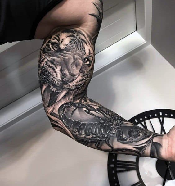 Black and grey full-sleeve tattoo featuring a fierce tiger's face, a detailed mechanical skeleton, and intricate shading for a bold and dynamic design.