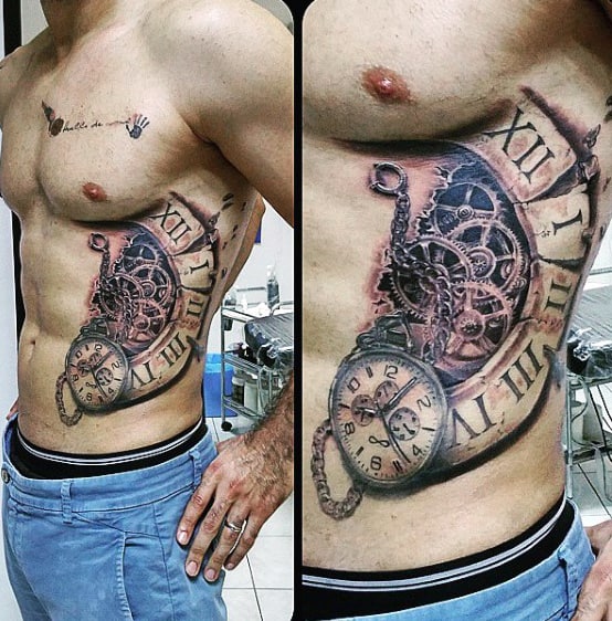 A man showing a detailed steampunk clock tattoo on his side and ribcage