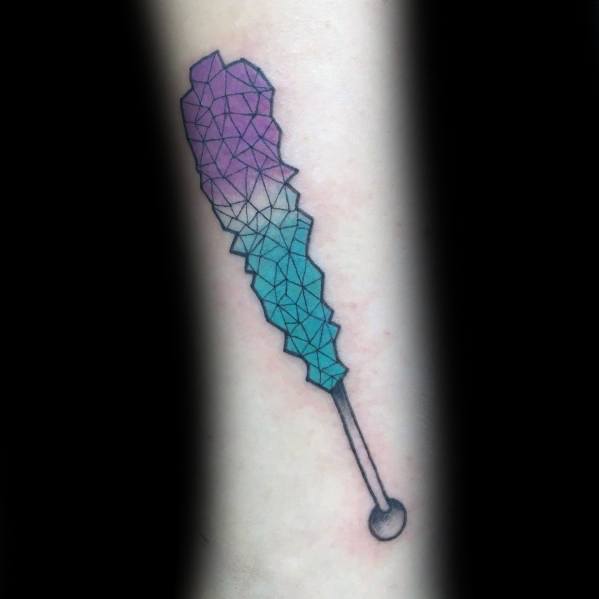 Geometric rock candy tattoo with a gradient of purple and blue hues, featuring fine line details that create a crystalline, faceted effect.