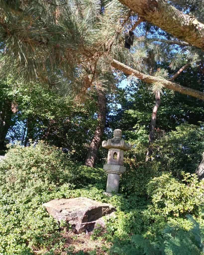 stone temple statue in backyard 