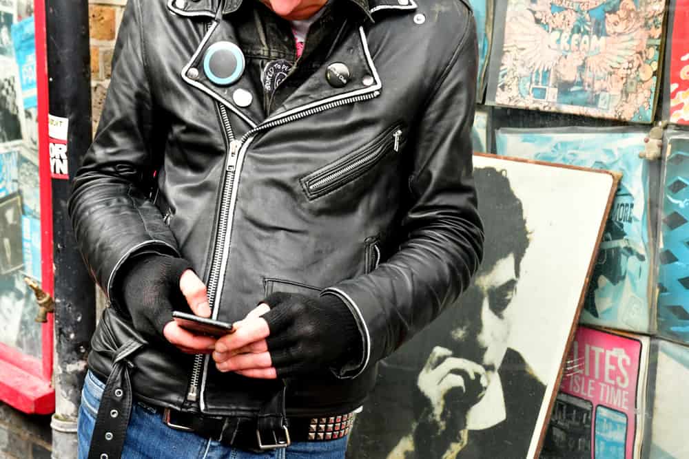 A close-up of a man in a rockabilly-style leather jacket