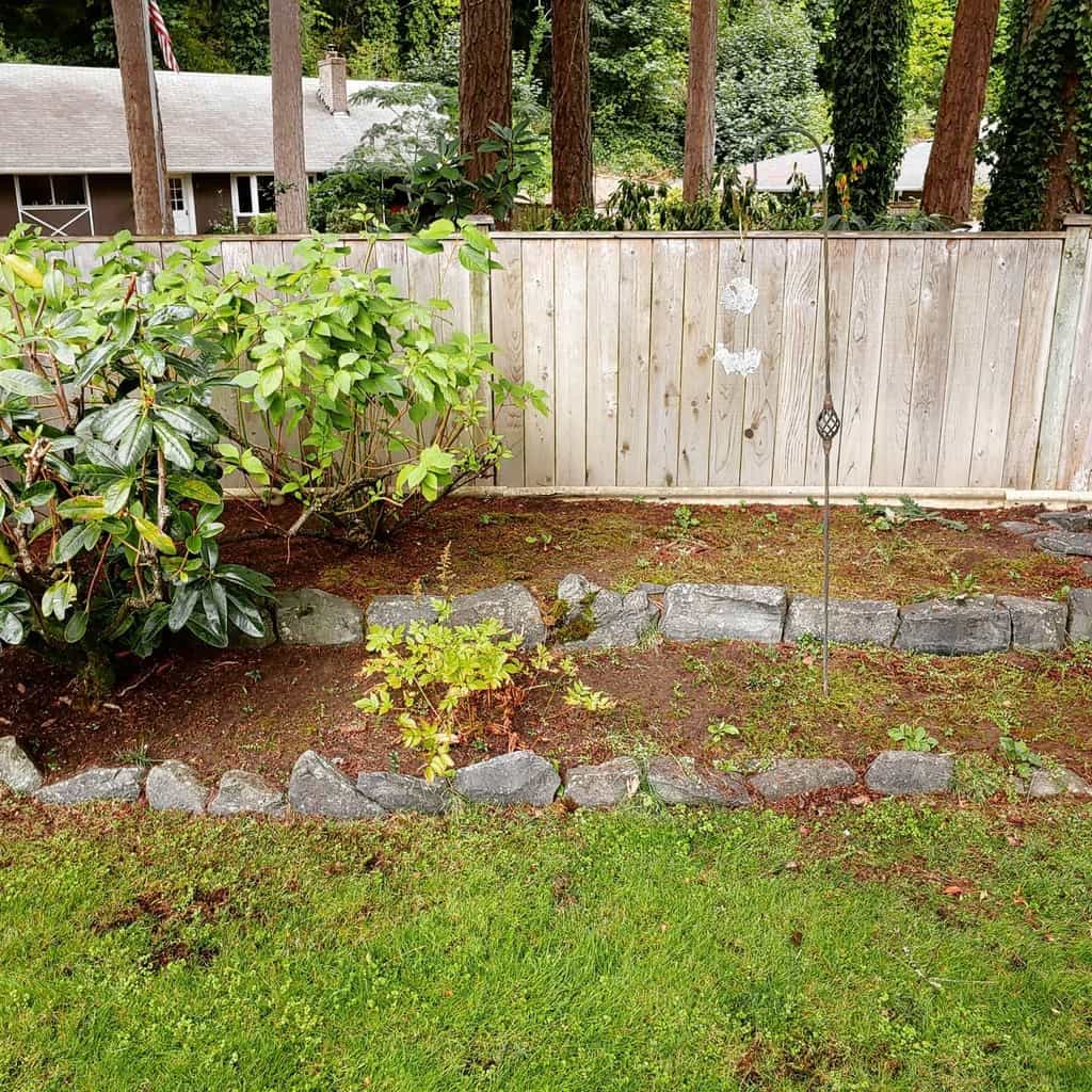 stone garden edging wood fence