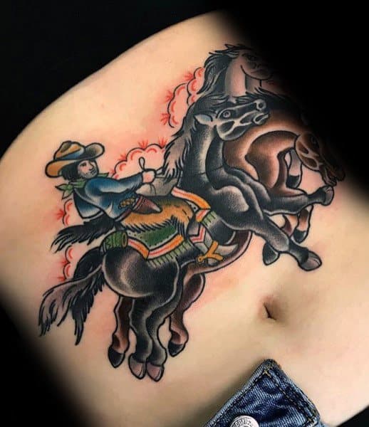 Traditional-style tattoo of a cowboy riding a bucking horse, featuring bold outlines, vibrant colors, and dynamic Western motion with decorative details.