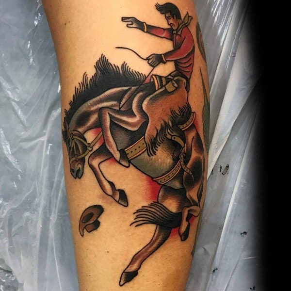 Traditional-style tattoo of a cowboy riding a bucking horse, featuring bold outlines, vibrant shading, dynamic motion, and a flying hat for added action.