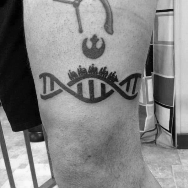 Black ink tattoo of a DNA strand shaped like a roller coaster, with silhouettes of riders and a Star Wars Rebel symbol above.