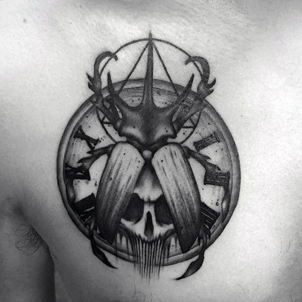 roman numeral clock with skull and scarab bettle mens upper chest tattoo