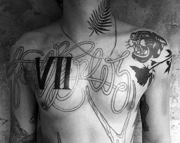 A tattooed chest with a blast over "VII," showcasing a panther and floral designs