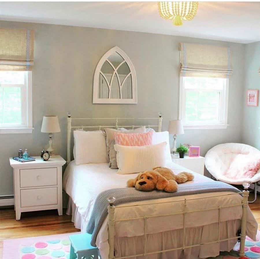 Charming kids' bedroom with green walls, dog plush toy, and white decor.