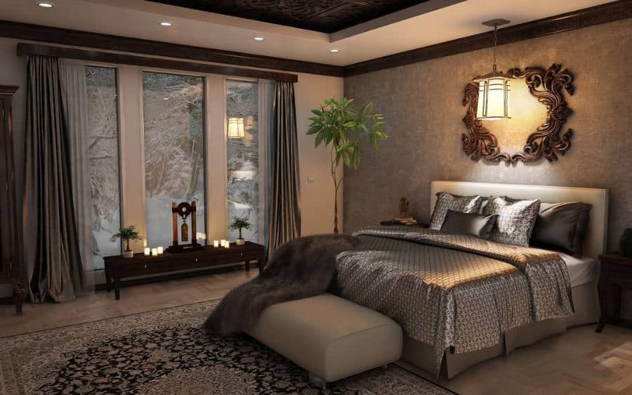 Cozy bedroom with a large bed, ornate decor, and a window view of a snowy landscape