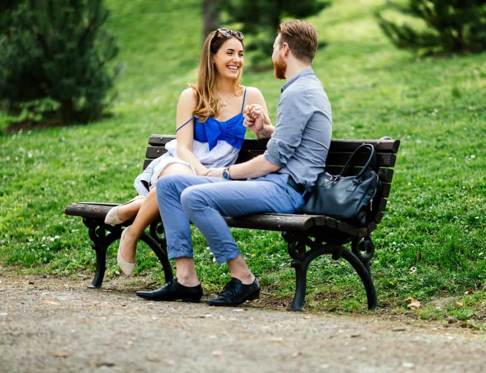 romantic couple sitting on a beach
