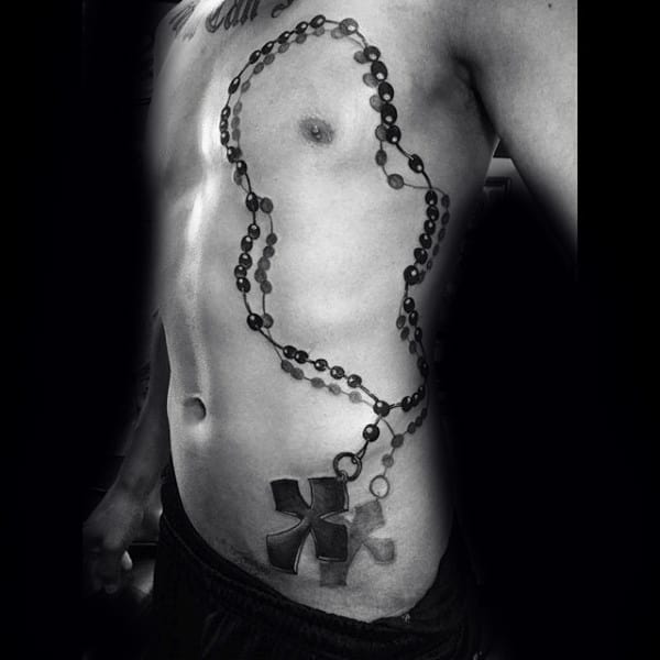 Bare torso with large rosary bead tattoo wrapping around the chest and stomach