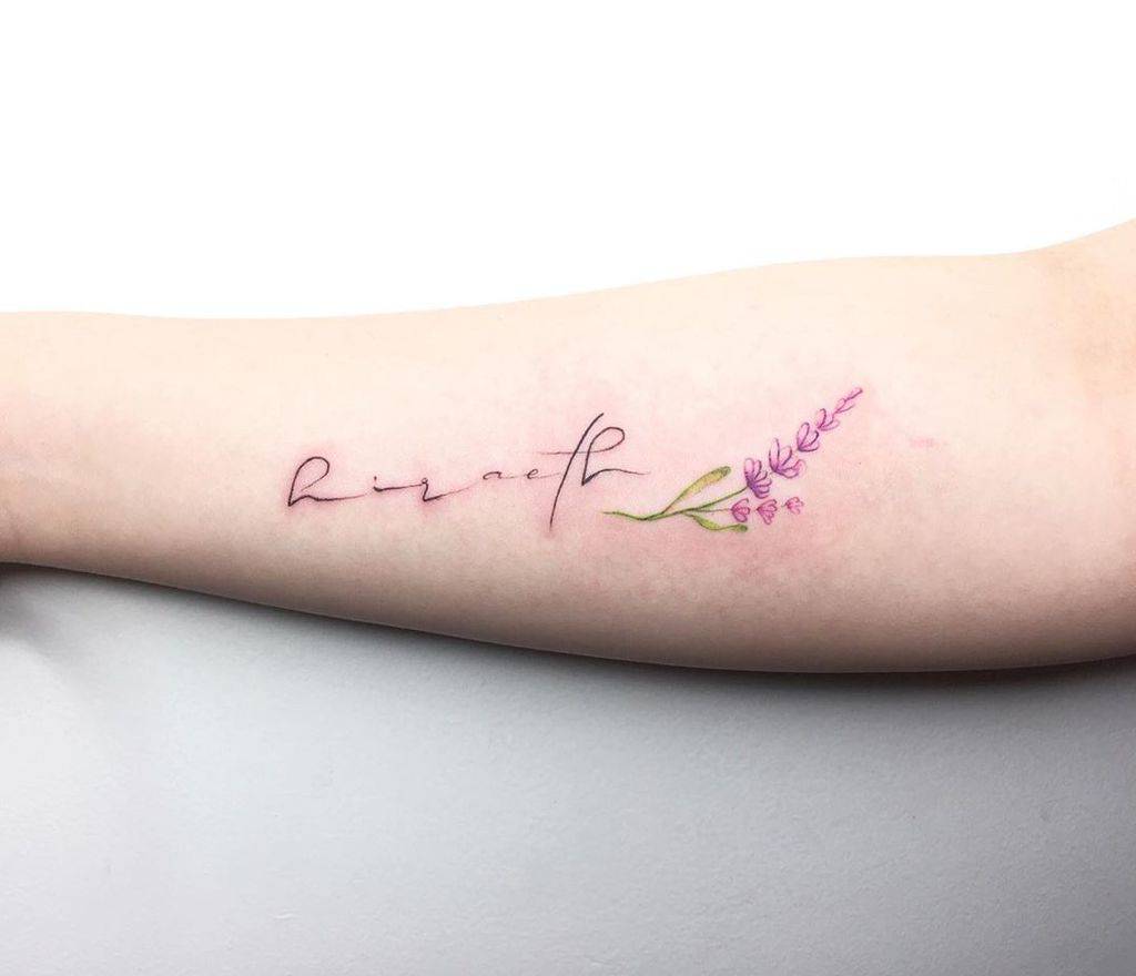 A tattoo featuring the word "respect" in elegant script, accompanied by a small sprig of lavender with delicate purple flowers and green leaves, placed on the forearm.