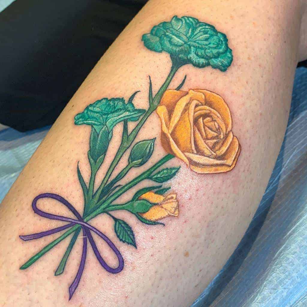 Tattoo of a yellow rose and green carnations tied with a purple ribbon on a person's skin