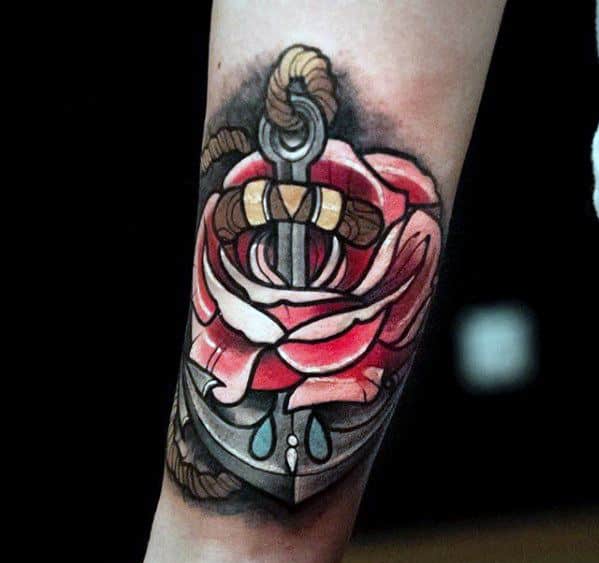 Tattoo of an anchor subtly intertwined with a blooming rose on a person's forearm