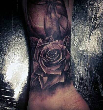 Black and grey rose tattoo on a wrist