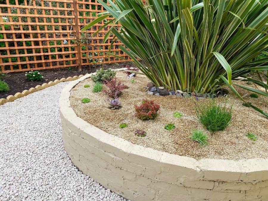 round brick wall flower bed lattice fence