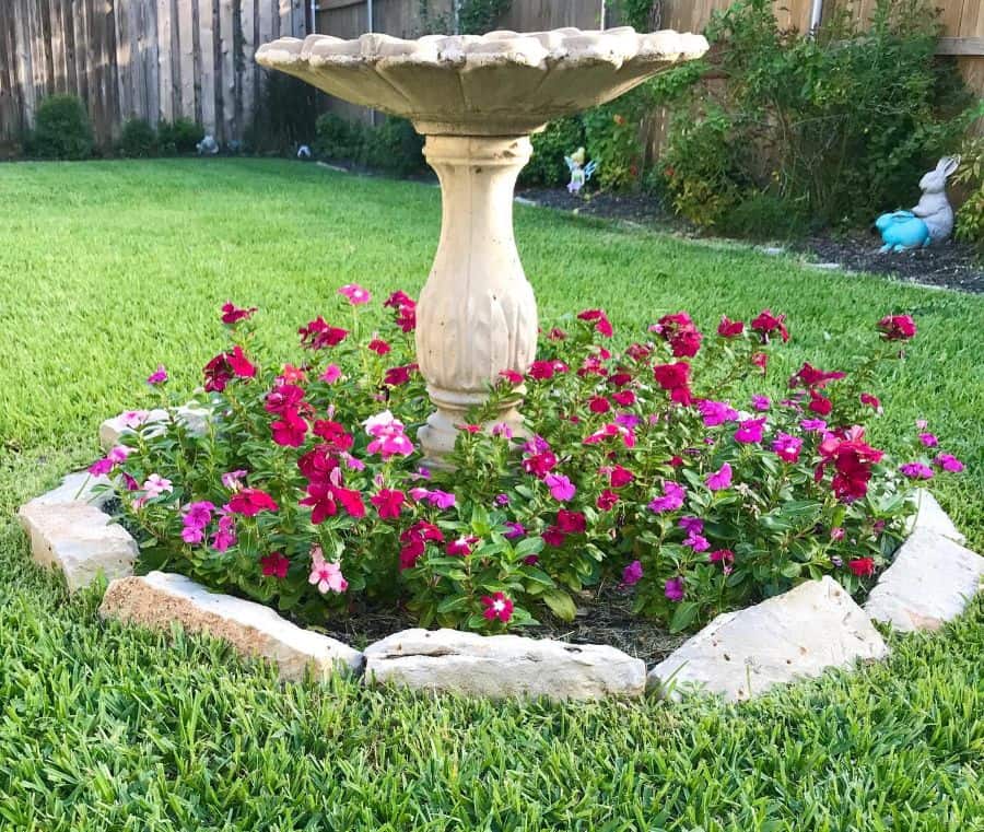 round stone wall flower bed fountain grass lawn