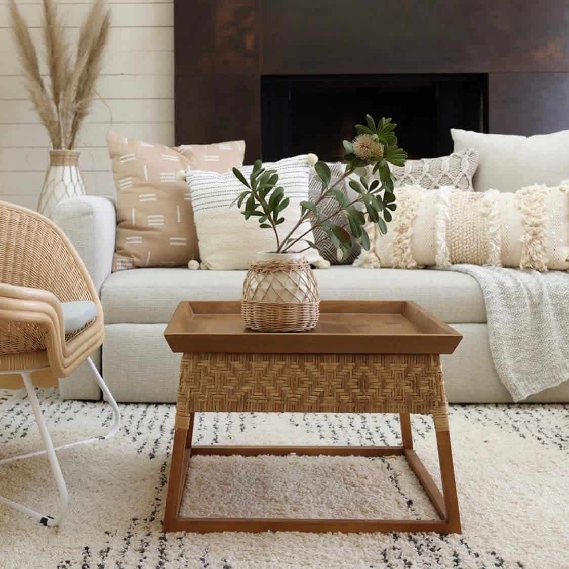 white sofa with beige pillows shiplap wall weaved coffee table 