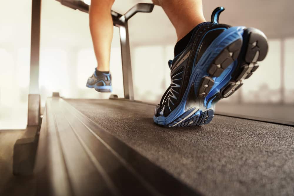 man running on treadmill with black shoes