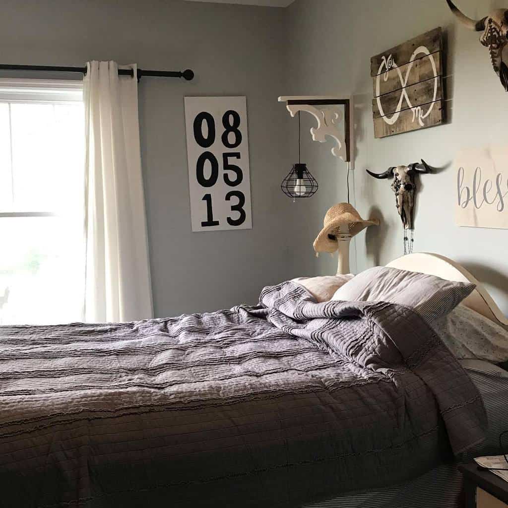 Rustic bedroom with farmhouse decor, vintage wall art, and cozy grey bedding.