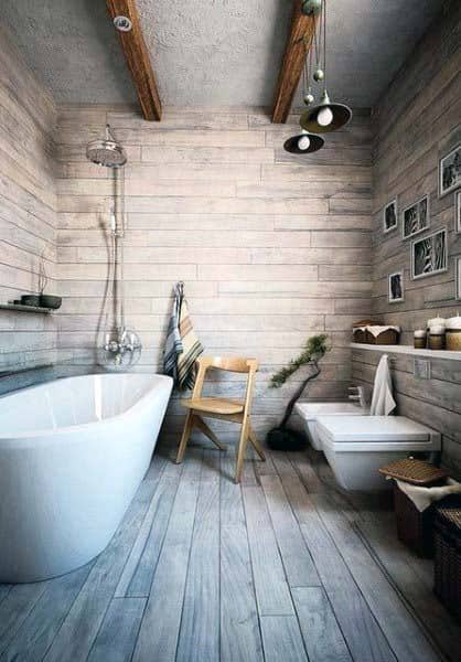 Rustic wood-themed bathroom with a bathtub, chair, toilet, and decorative frames on the wall