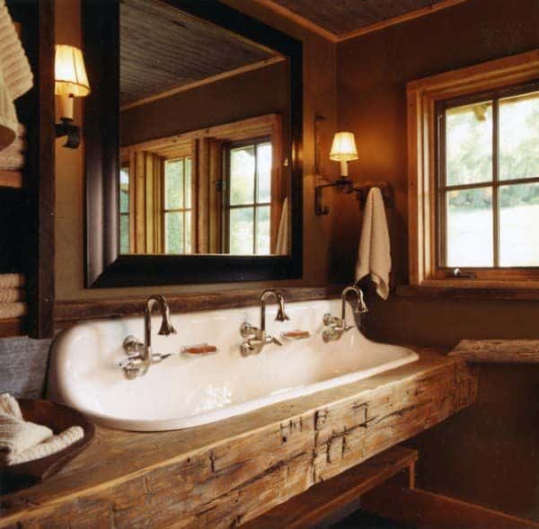 Rustic bathroom with double sink, wooden accents, and picturesque window views