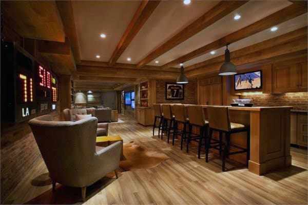 Rustic basement with exposed wooden beams, home bar, and cozy seating area.
