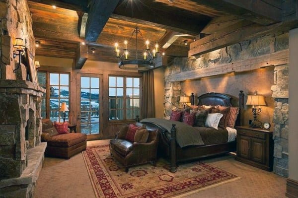 luxury stone bedroom with fireplace and chandelier