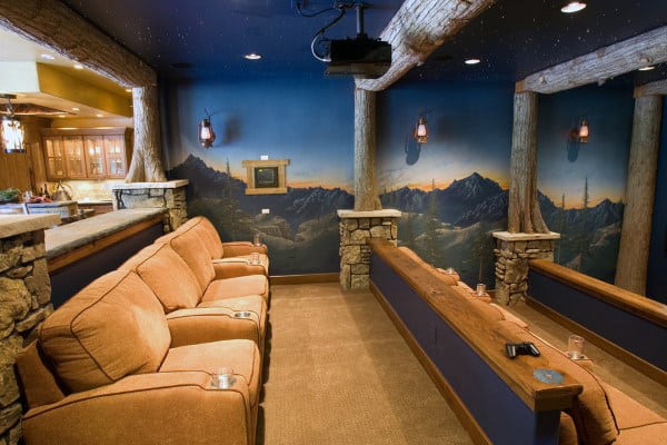 Home theater room with cozy seating, starry ceiling, and mountain mural on walls