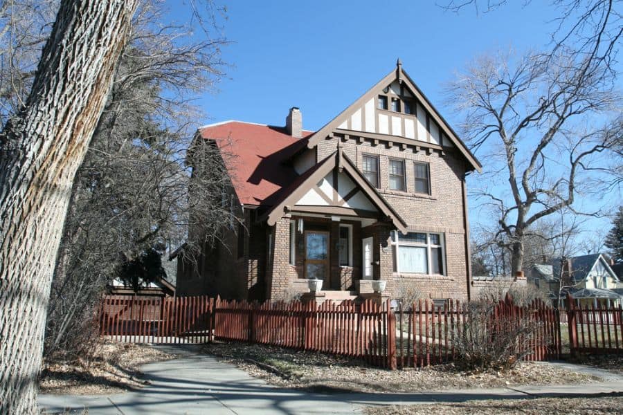 rustic brick craftsman style house red fence