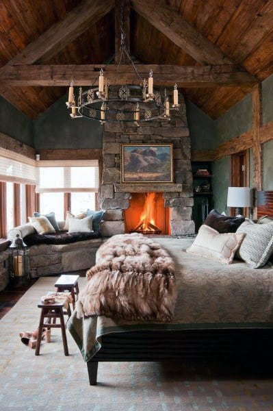 wood cabin style bedroom with stone fireplace