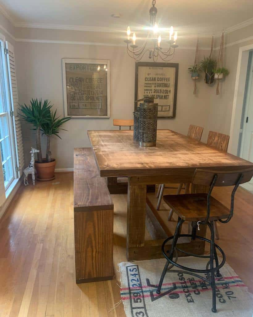 small rustic dining room wood table chairs and bench chandelier