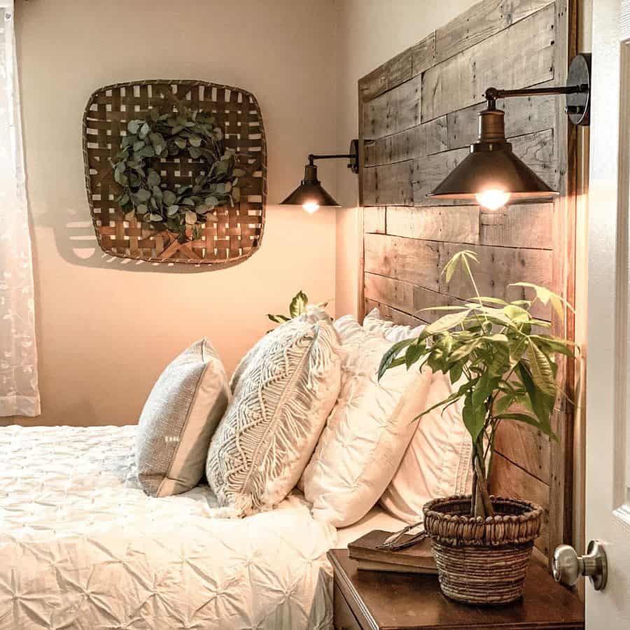 Cozy bedroom with a rustic wooden headboard, wall-mounted lamps, and a potted plant on a bedside table