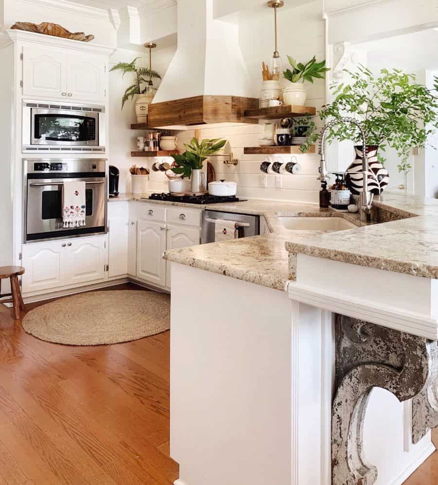 farmhouse kitchen with white cabinets and wood accents