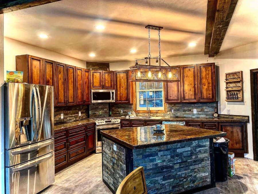 rustic farmhouse kitchen wood cabinets and cupboards stone island pendant lighting 