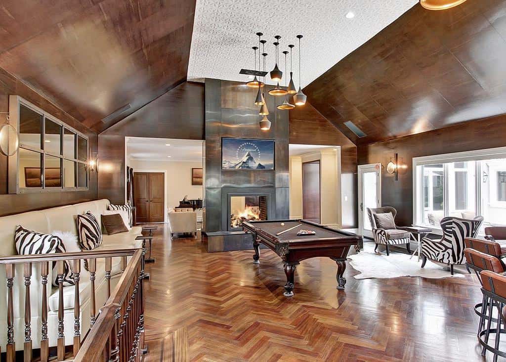 large rustic living space fireplace billiards table sofa table and chairs