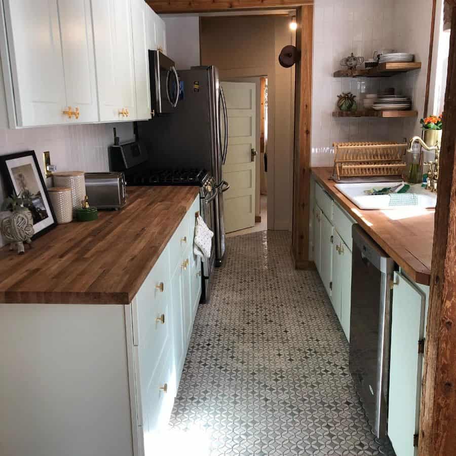 rustic galley kitchen mosaic tile floor white cabinets wood bench tops