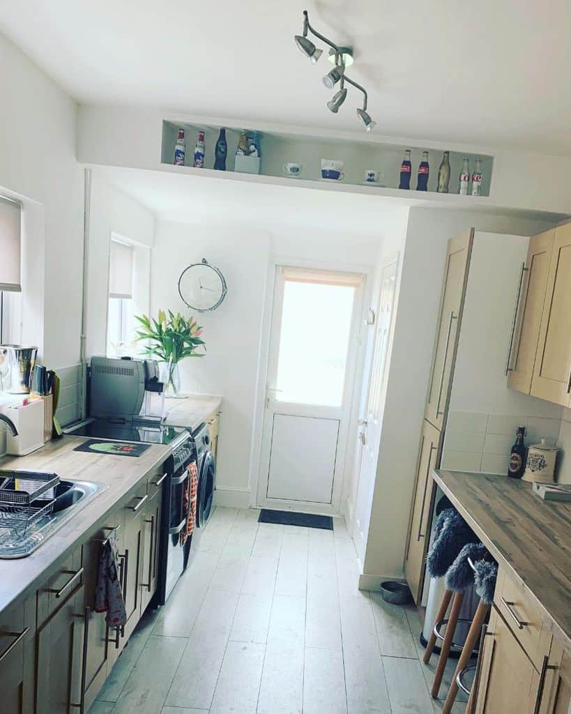 small rustic galley kitchen recessed wall shelf wood vinyl flooring