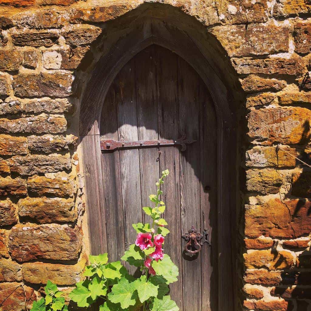 rustic wood gate stone fence