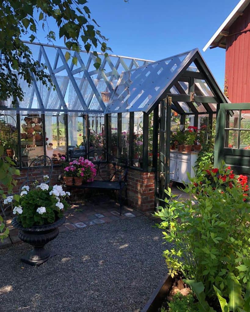 rustic brick and wood greenhouse colorful roses white cabinet