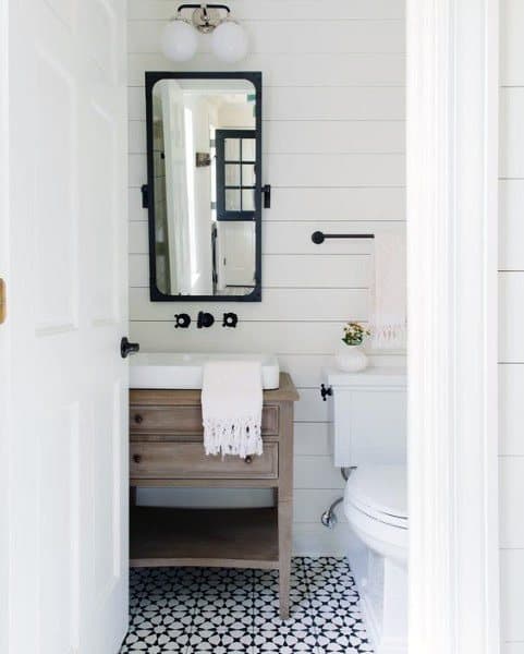 white shiplap wall bathroom with black and white tile flooring
