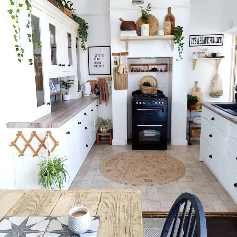 white rustic kitchen with cabinets and tile floor