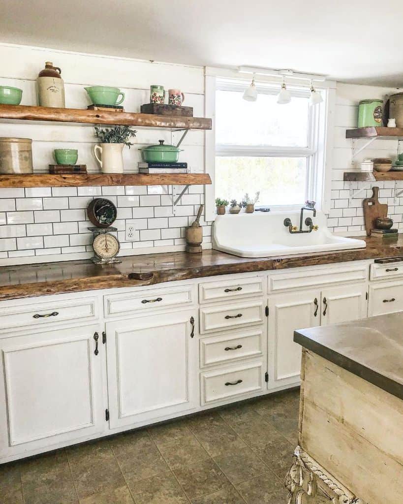 rustic white cabinet kitchen with wood countertop and white tile backsplash