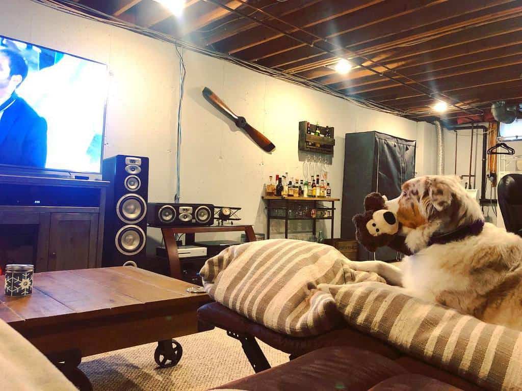 basement man cave with exposed ceiling