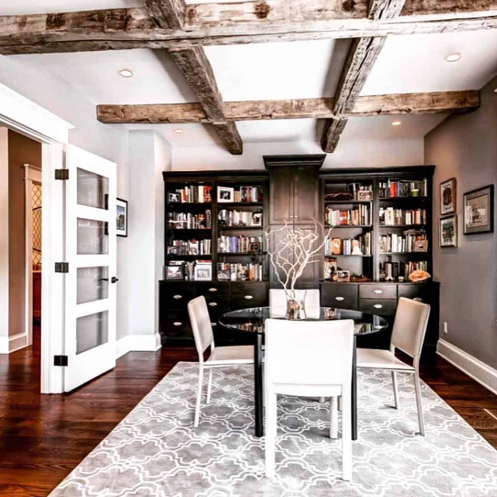 dining room with exposed wood beam ceiling and black cabinet